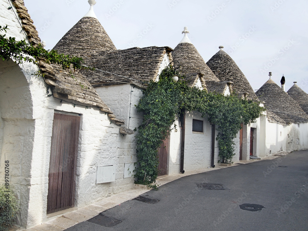 white Trulli of Alberobellowith roofs cone-shaped in Puglia