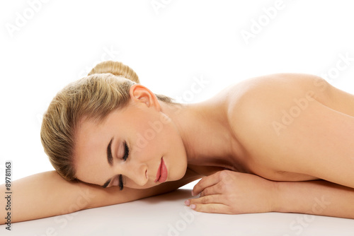 Beautiful young slim woman lying on belly.
