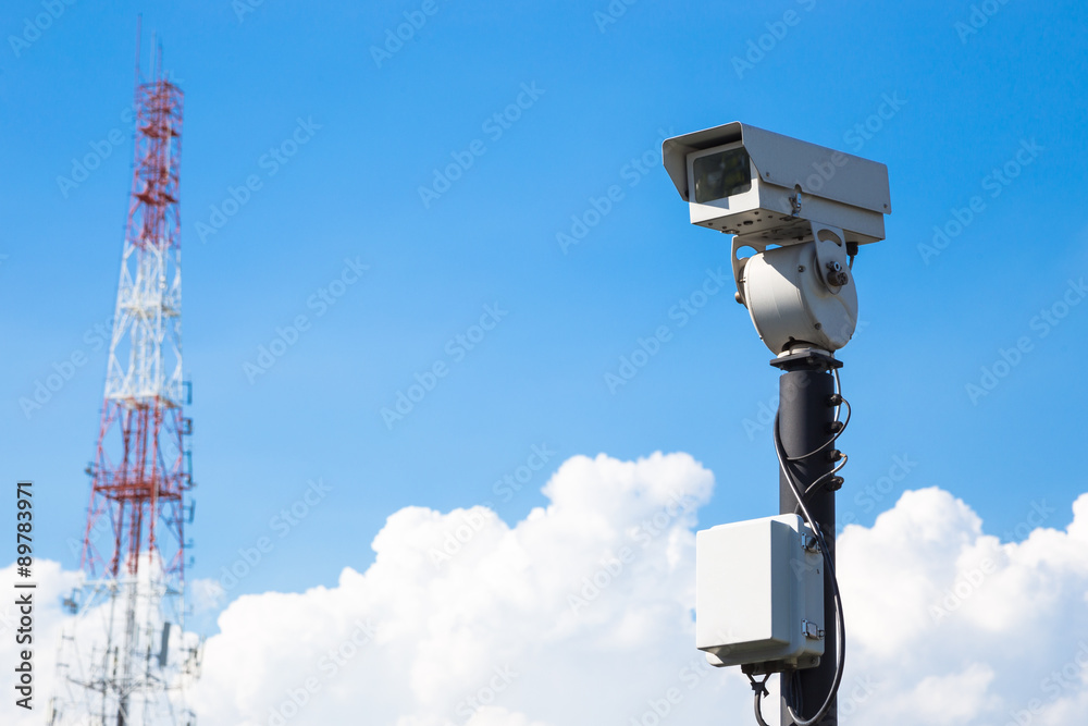 closed circuit camera and tower Radio wave signals outdoor on blue sky closed circuit camera and tower Radio wave signals outdoor on blue sky