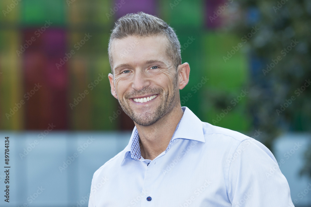 Mature Man Smiling At The Camera. He is outside of the office. Mature Man Smiling At The Camera. He is outside of the office.