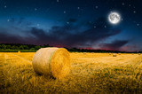 hay bales in the night. Elements of this image furnished by NASA.