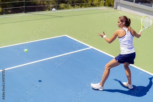 Beautiful female tennis player in action © NDABCREATIVITY