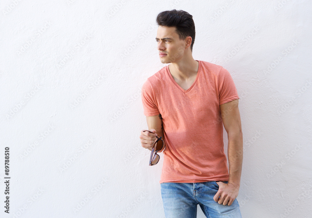Handsome man standing against white background