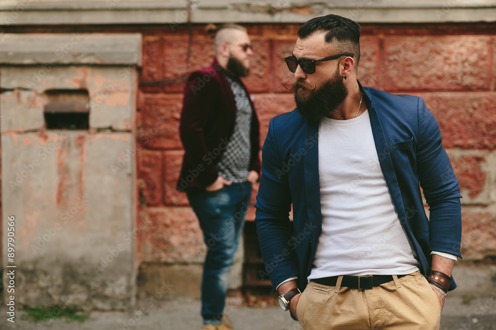 Two bearded businessman looking at phone