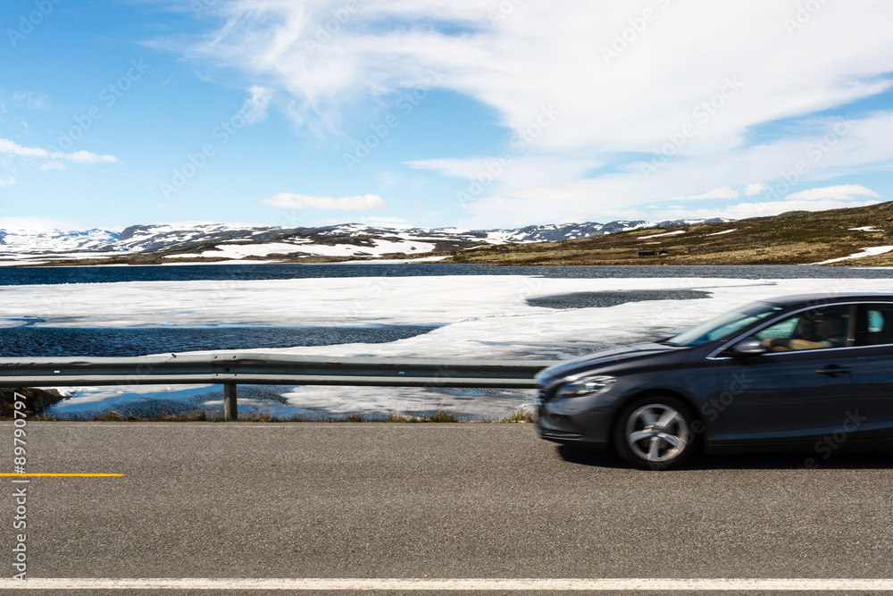 Car driving on Hardangervidda road in Norway