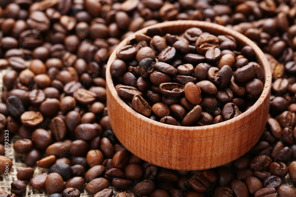 Coffee beans in bowl on the beans background