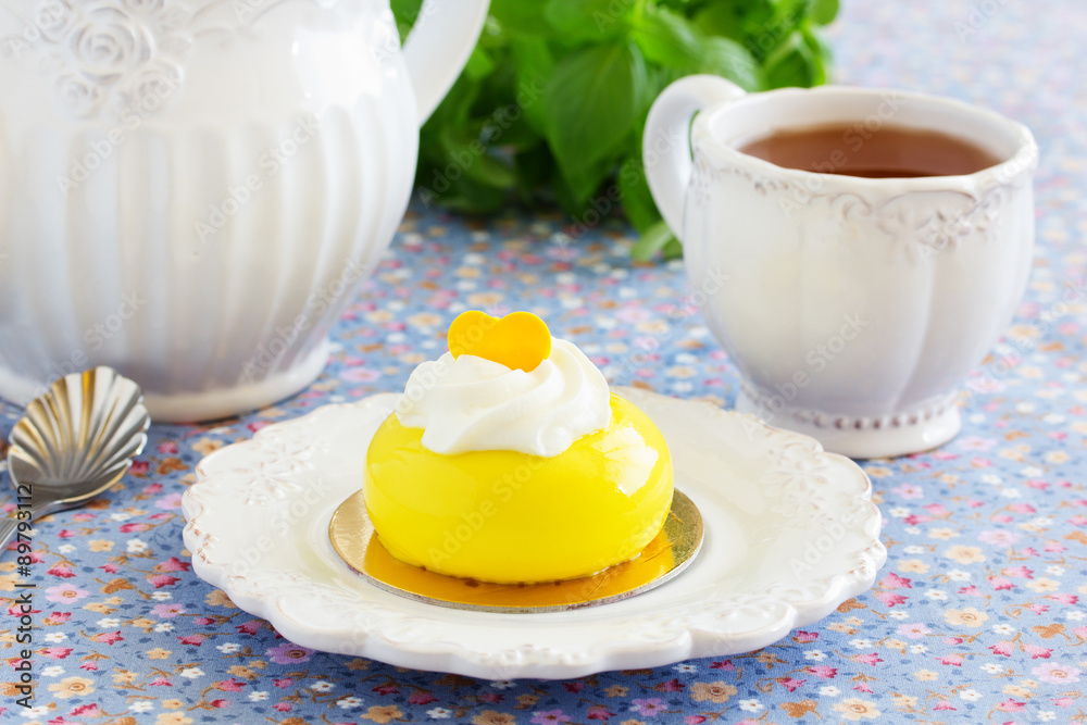 Cakes with mango and passion fruit with cream in the mirror glaze. Selective focus. Cakes with mango and passion fruit with cream in the mirror glaze. Selective focus.