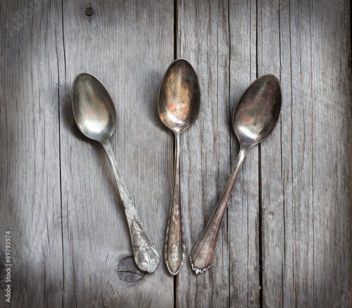 Vintage spoons with patina on wood