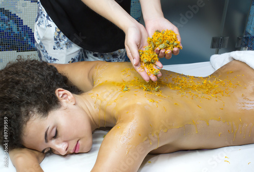 processes honey massage girl in a spa salon