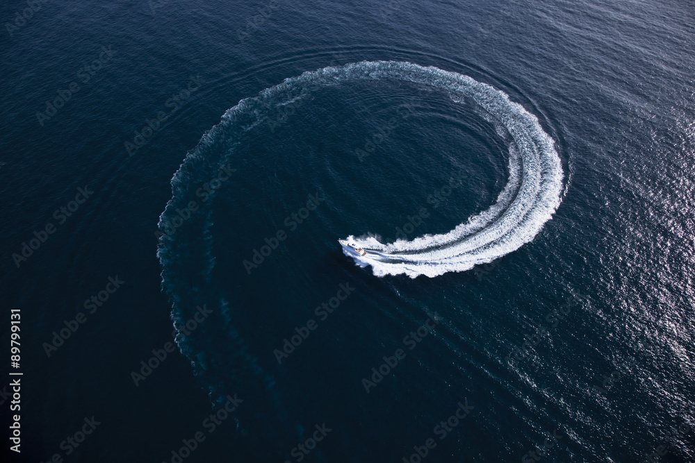 Motor boat making a turn in form of a swirl