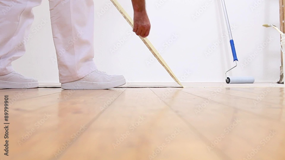 painter man at work, removes the tape from the floor
painter man at work, removes the tape from the floor
