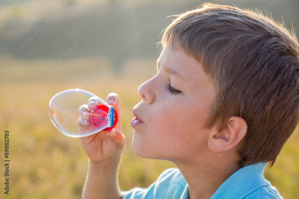 Boy blowing up the soap bubbles Boy blowing up the soap bubbles