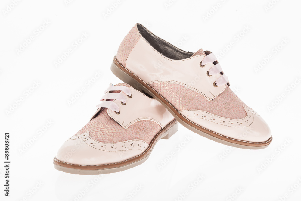 shoe made of pink leather with laces for women on white background shoe made of pink leather with laces for women on white background