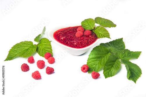 Raspberries jam with berries and leavies photo