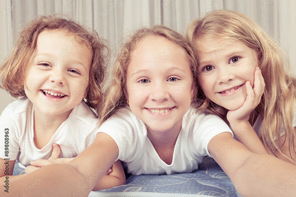 Portrait of happy children which are lying on the floor in the h Portrait of happy children which are lying on the floor in the h