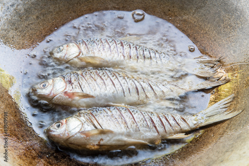 Fry fishs in hot oil in the pan,Thai style food