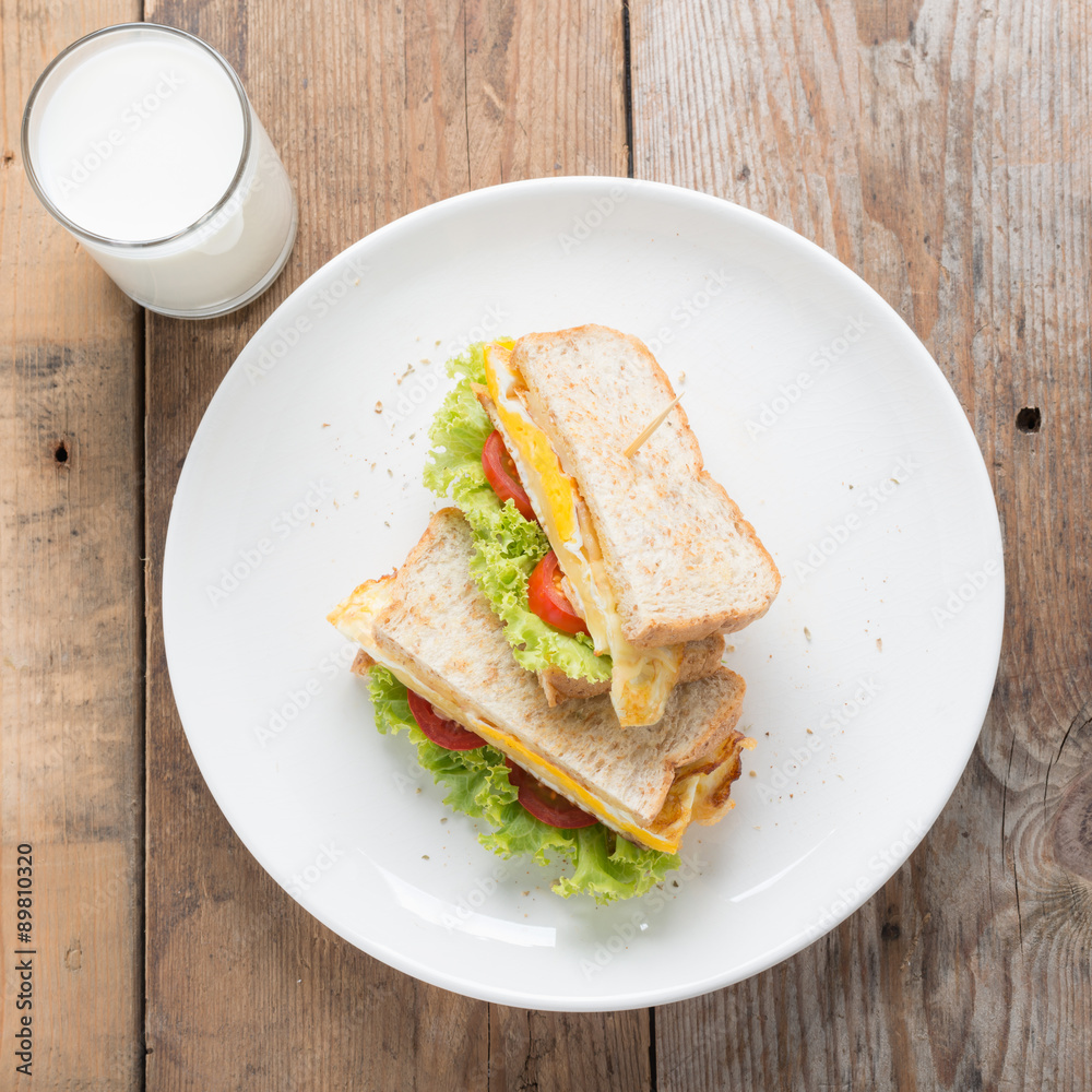 Sandwichs fried egg with cheese and milk on wood table. Sandwichs fried egg with cheese and milk on wood table.