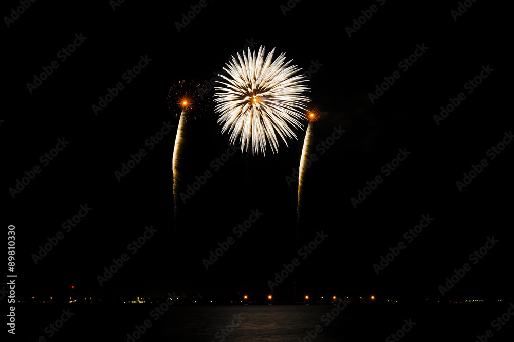 A summer night's fireworks display with beautiful colors against a dark night sky. A summer night's fireworks display with beautiful colors against a dark night sky.