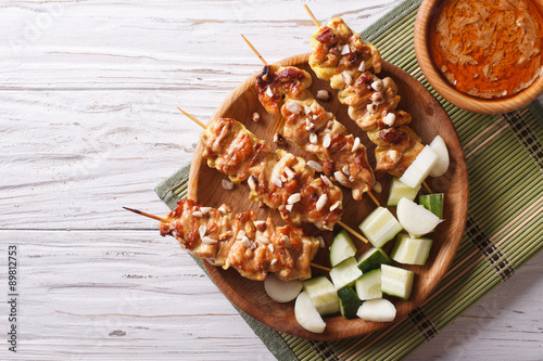 Chicken satay with a delicious peanut sauce. horizontal top view
