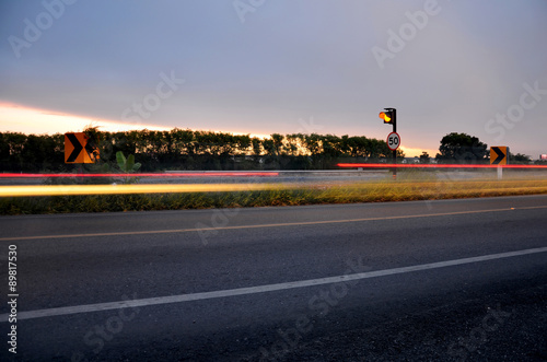 Light motion blured of car in morning on the road