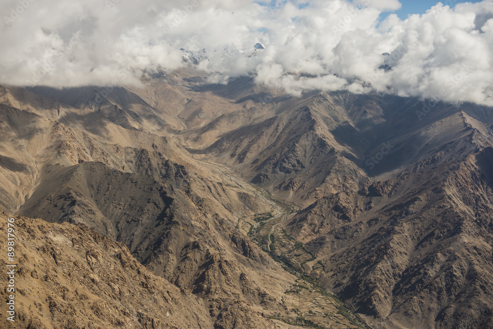 Aerial view of desert and high mountain from the airplane window. New Delhi-Leh flight ,India. Aerial view of desert and high mountain from the airplane window. New Delhi-Leh flight ,India.