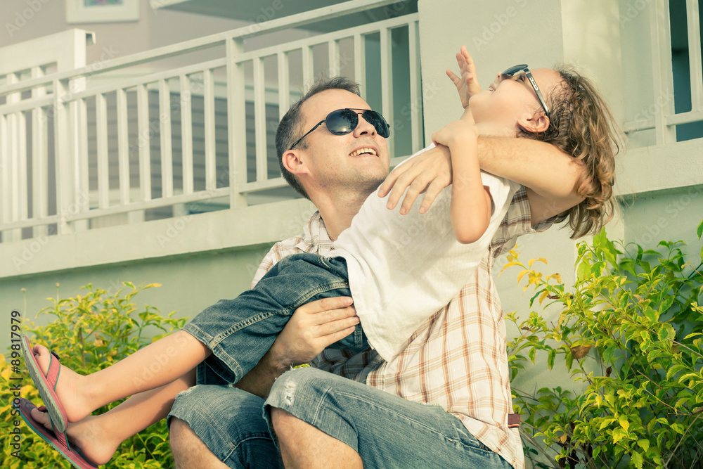 Obraz premium Dad and son playing near a house at the day time.