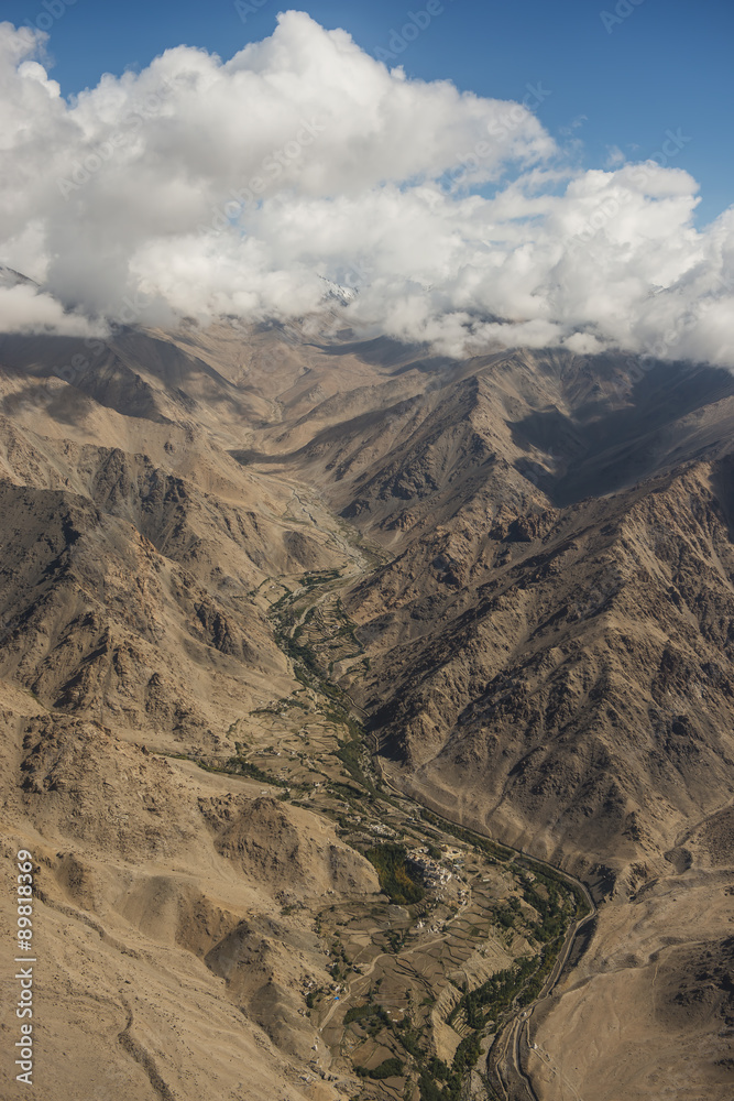 Aerial view of desert and high mountain from the airplane window. New Delhi-Leh flight ,India.