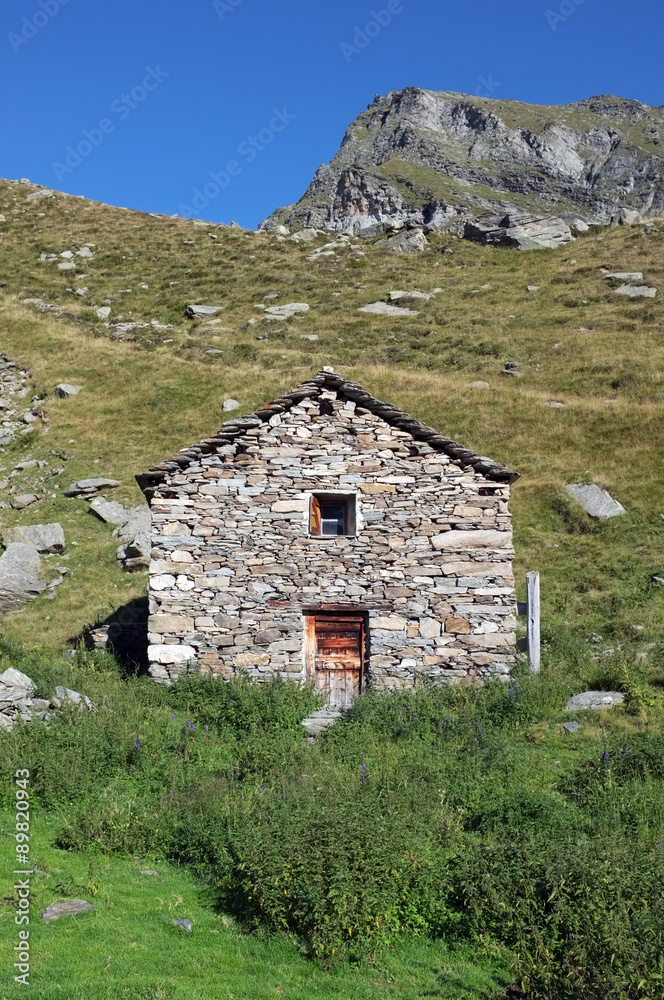 Beautiful hut made of stones in the swiss alps