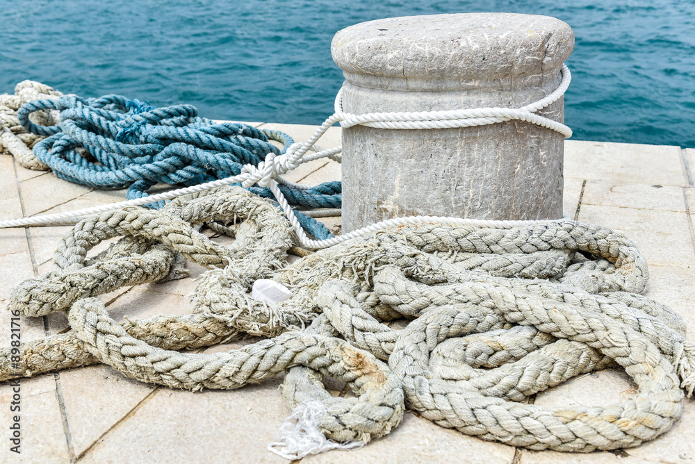 Fototapeta premium Old Stone Mooring on a stone paved pier