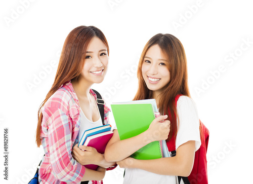 Two happy teenage students girls isolated on white