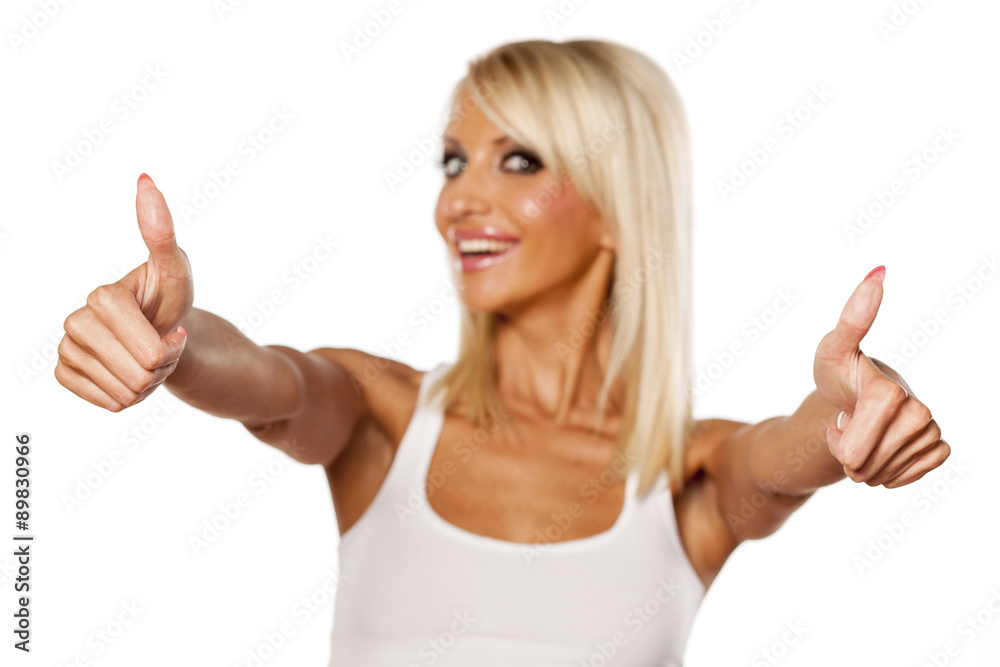 happy young blonde showing thumbs up happy young blonde showing thumbs up