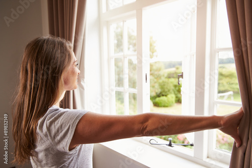 Woman Standing By Bedroom Window And Opening Curtains Free Download Woman Standing By Bedroom Window And Opening Curtains - GFXLoad