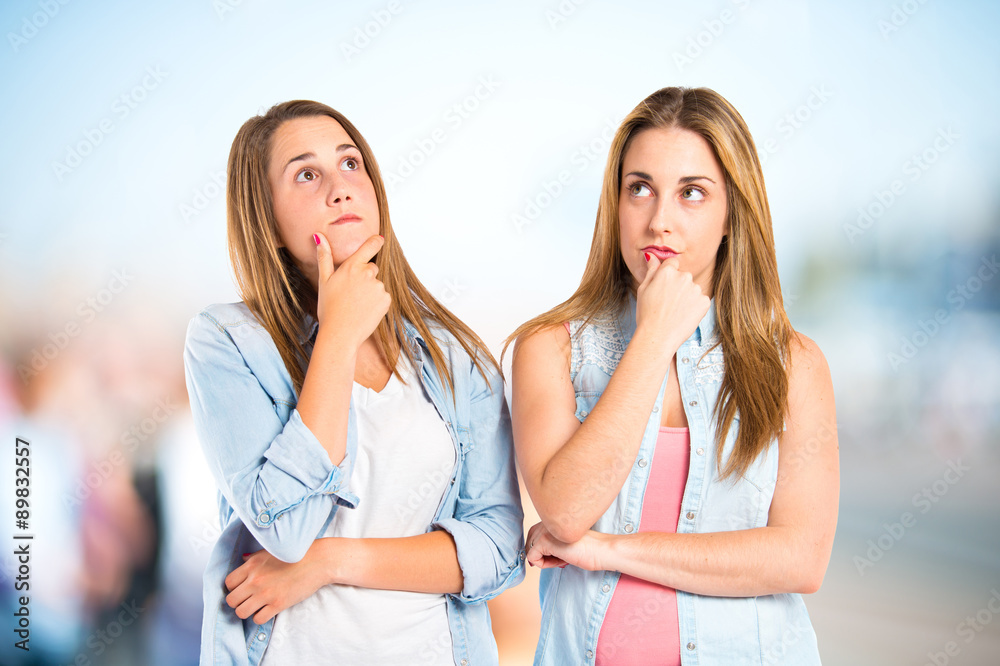 Girls thinking over isolated white background Girls thinking over isolated white background