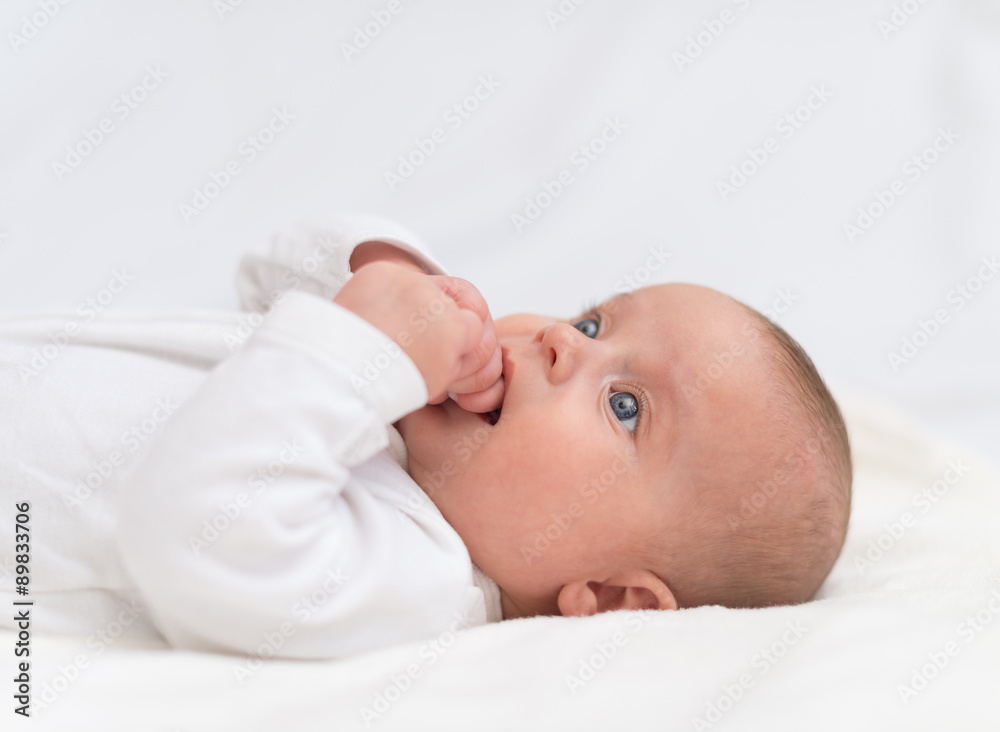 Cute little baby on the bed. Place for your text.
