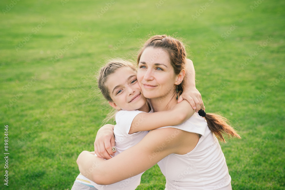 Mother hugging her child during the walk in the park Mother hugging her child during the walk in the park