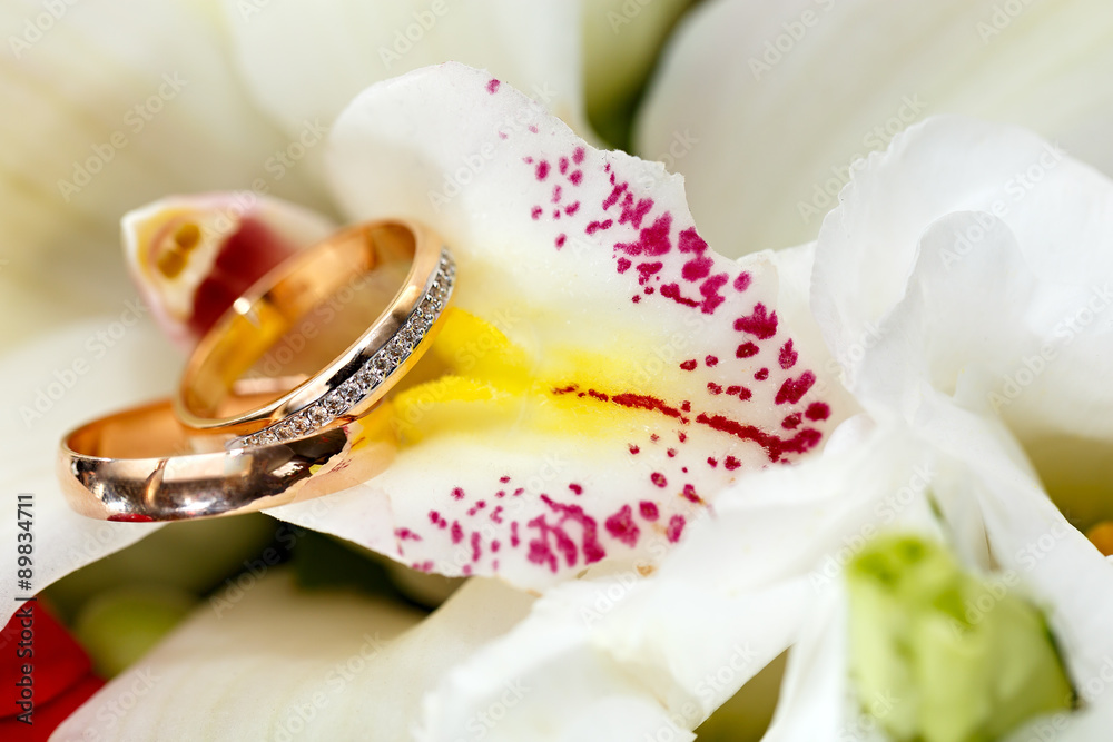 Gold wedding rings on a bouquet of flowers for the bride