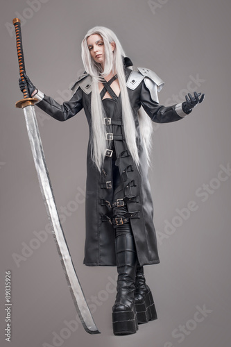 Fantasy woman warrior / Woman warrior with sword and armor isolated on the gray background photo