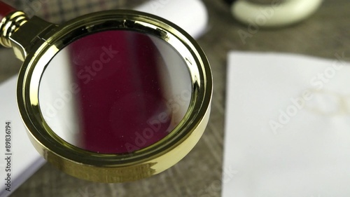 Wrapped paper sheets and magnifying glass