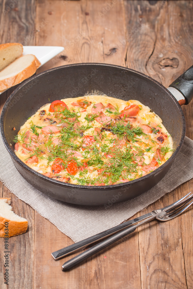 Omelette with sausage, onion, herbs and tomatoes Omelette with sausage, onion, herbs and tomatoes