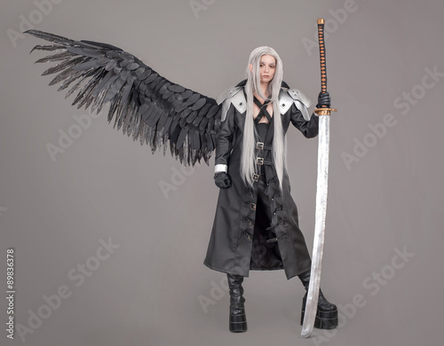 Fantasy woman warrior / Woman warrior with sword and wings isolated on the gray background