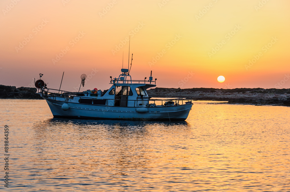 Fishing boat lies at sundown 
