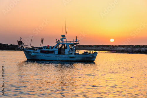 Fishing boat lies at sundown 