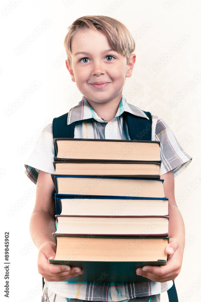 Boy carrying a stack of books Boy carrying a stack of books