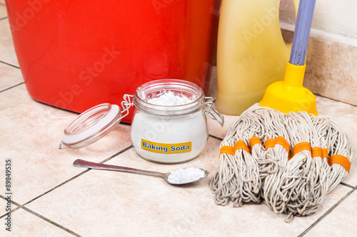 Baking soda with pail, mop, detergent for house cleaning.