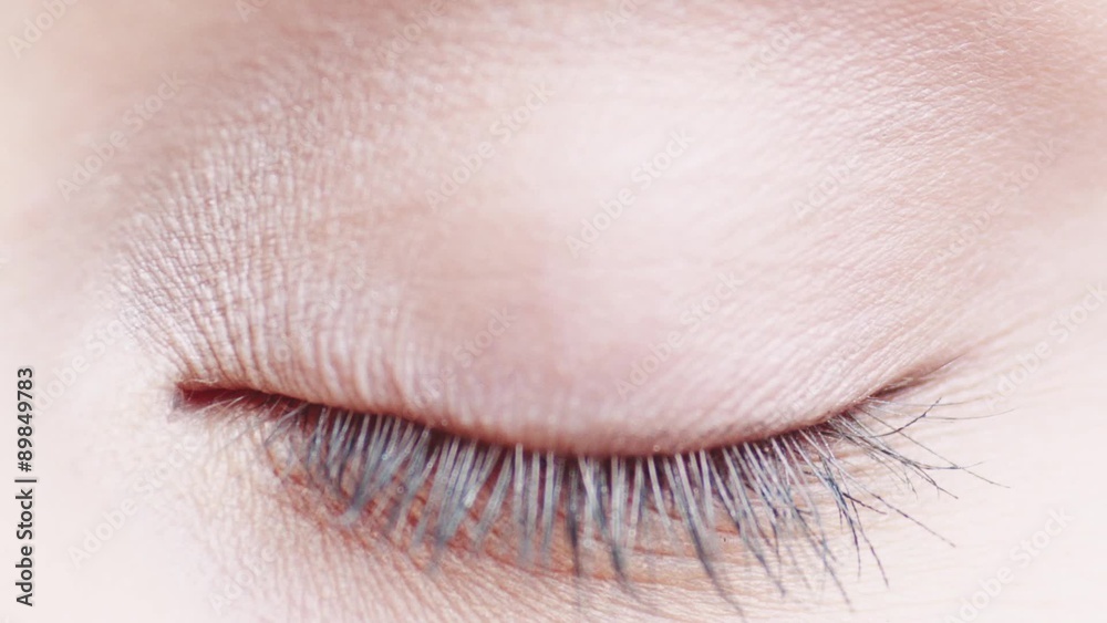 Macro Close-up eye blinking. Slow Motion, 120 fps. Young Woman is opening and closing her beautiful eye.