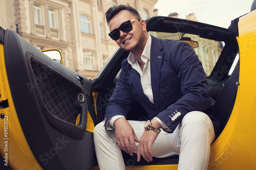 Stylish man sitting in sport car photo