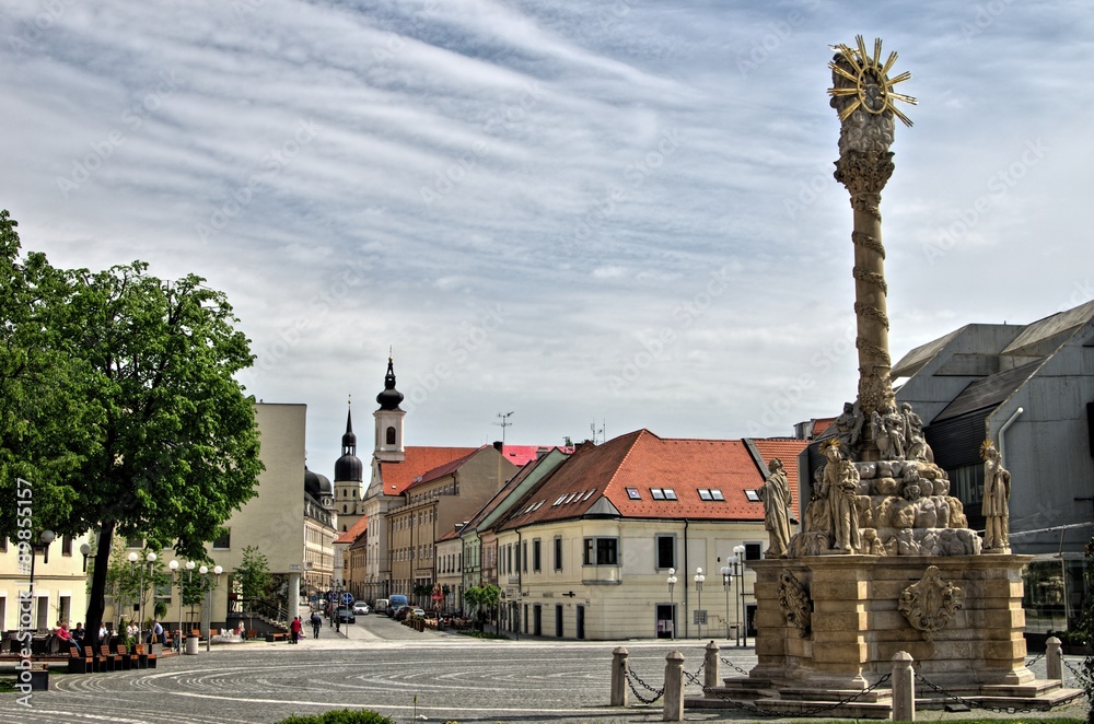 TRNAVA, SLOVAKIA Local and visitor stroll the Trojicne square, near the city tower, In Trnava, Slovakia