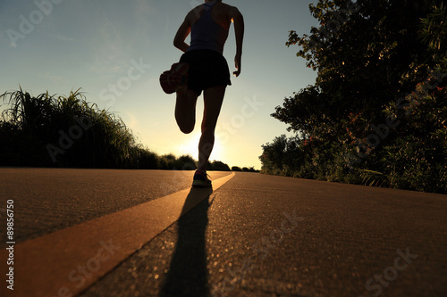 Fototapeta Naklejka Na Ścianę i Meble -  young fitness woman running on sunrise seaside trail