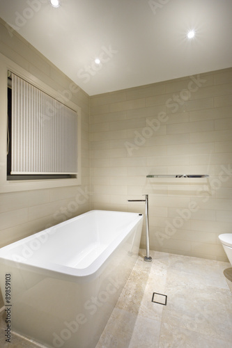 A modern tub in a minimalistic bathroom