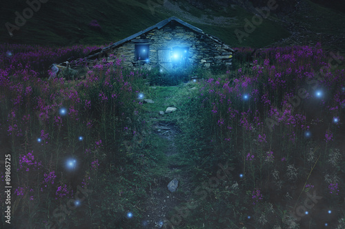 Mysterious mountain cabin with magical lights